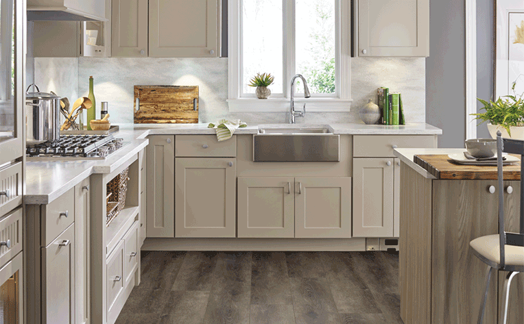 luxury vinyl plank flooring in bright kitchen with marble-look backsplash tile