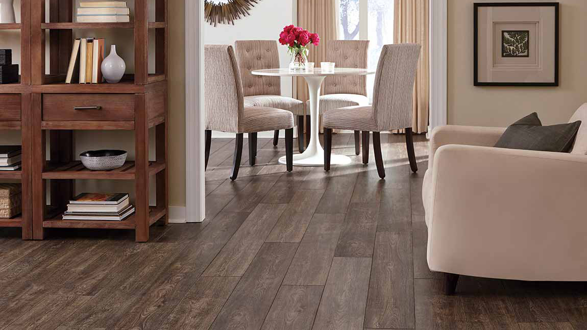 Laminate flooring in a living and dining room, installation services available.